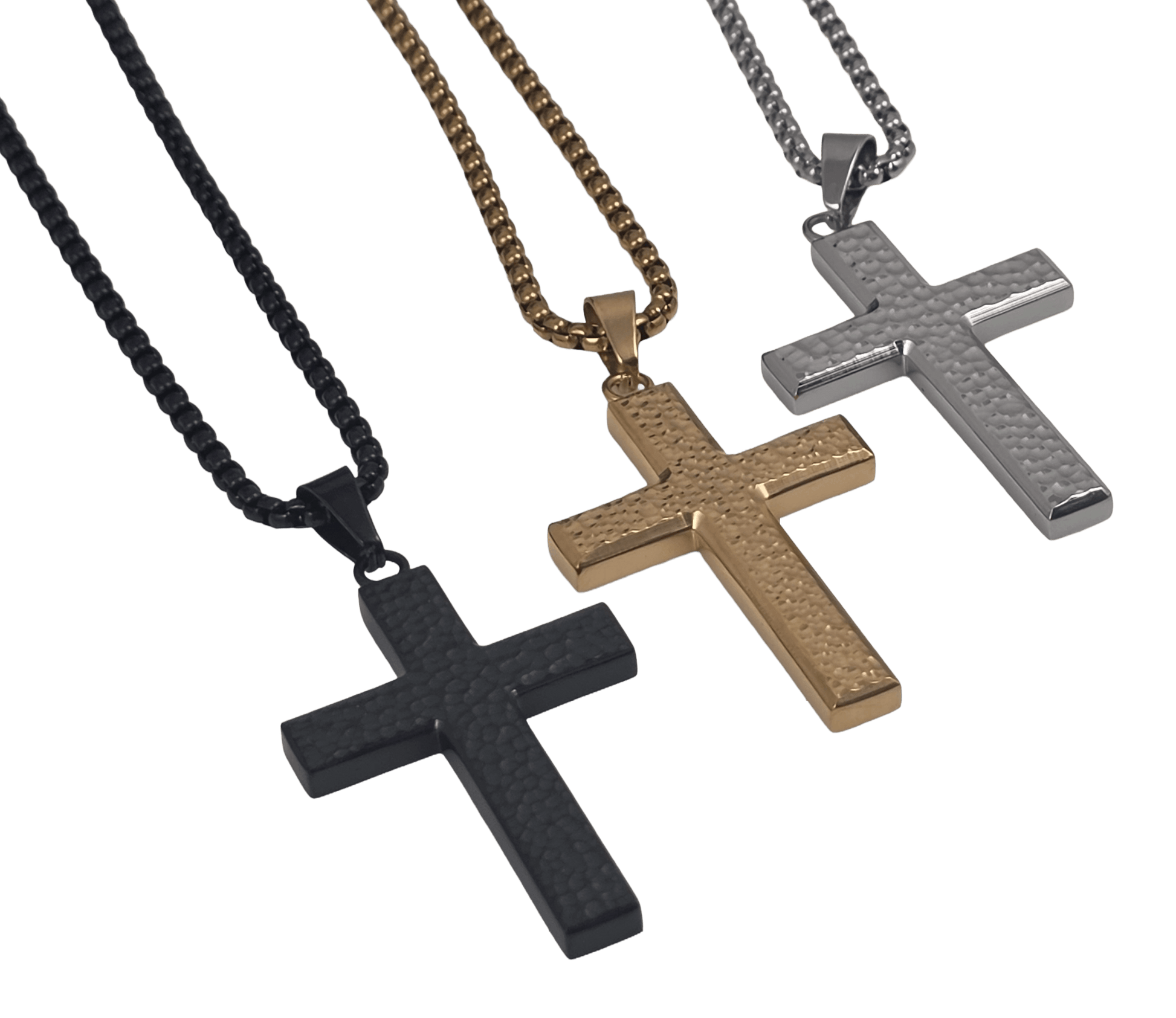 angled view of an all-black or all gold and all silver IP-plated stainless steel cross pendant featuring a rugged, hammered dimple texture on the main body, framed by polished edges, hanging on a black box chain against a black background.