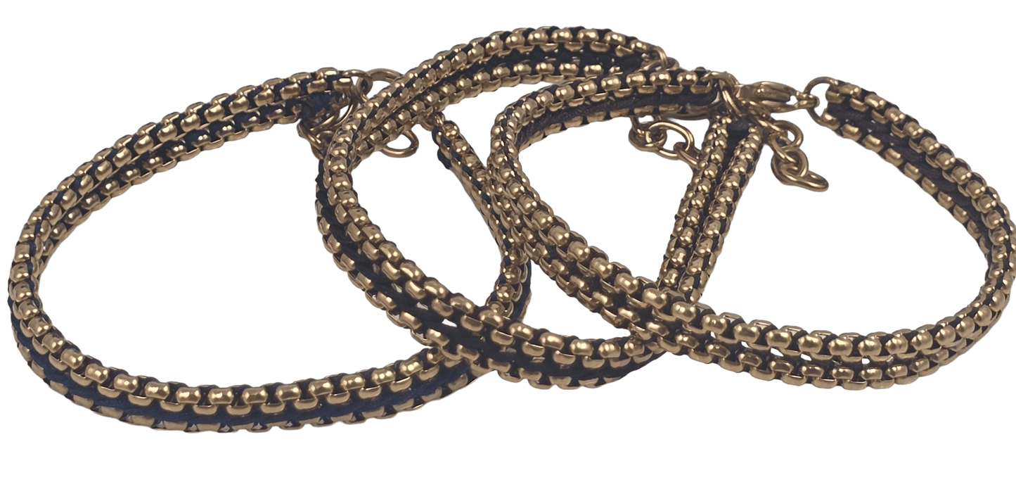 Close-up view of the woven thread detail 3 color thread black, brown and blue on the gold stainless steel link bracelet.