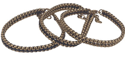 Close-up view of the woven thread detail 3 color thread black, brown and blue on the gold stainless steel link bracelet.