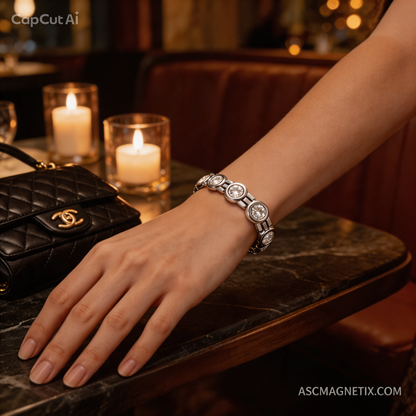 Women wearing a silver-toned stainless steel bio-health magnetic crystal bracelet with a black evening bag and glowing candles in the background.